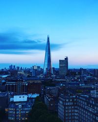 View of cityscape against cloudy sky