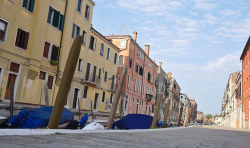 Street amidst buildings in city against sky