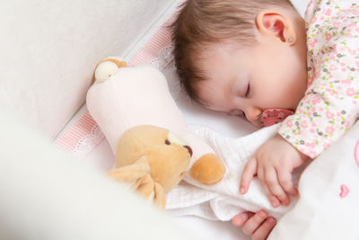 High angle view of baby sleeping on bed