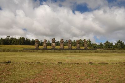 Hay bales on field against sky