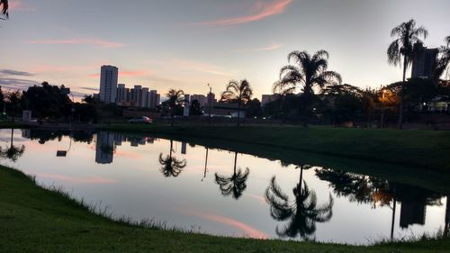 Calm lake with buildings in background