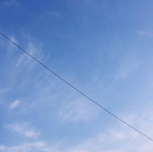 Low angle view of birds flying against sky