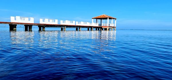 View of swimming pool by sea against sky