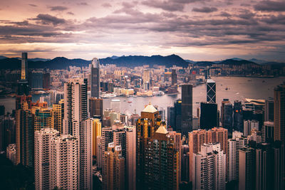 Aerial view of buildings in city against sky during sunset