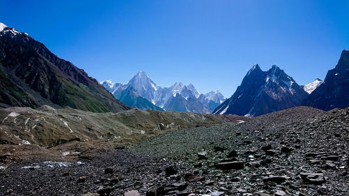 Scenic view of snowcapped mountains against clear blue sky