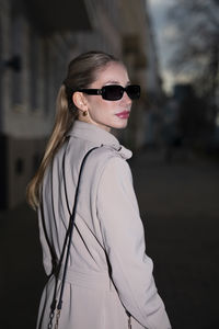 Young woman wearing sunglasses standing outdoors