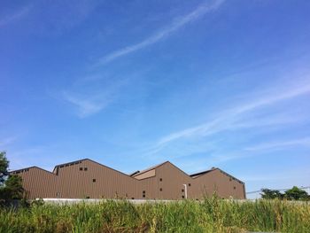 Built structure on field against blue sky