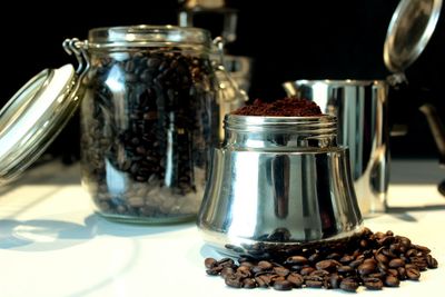 Close-up of coffee beans in jar on table