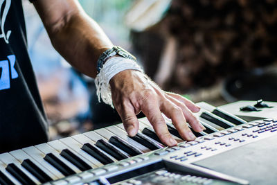 Midsection of man playing piano