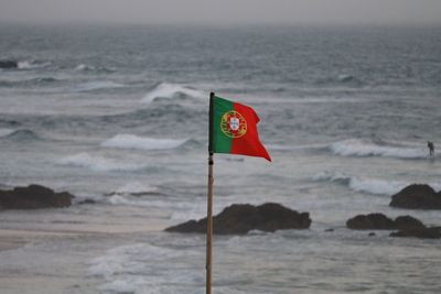 Portuguese flag against sea