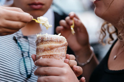 Midsection of friends having ice cream