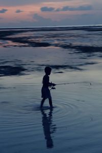 Silhouette of man at beach during sunset