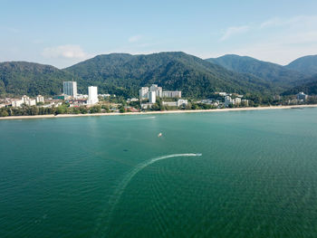 Scenic view of sea and buildings against sky