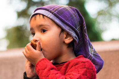 Portrait of cute girl looking away outdoors
