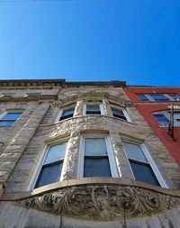 Low angle view of building against blue sky