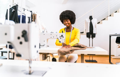 Close-up of fashion designer working at studio