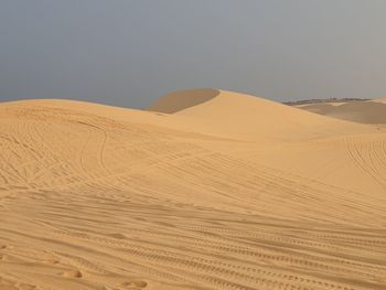 Scenic view of desert against clear sky