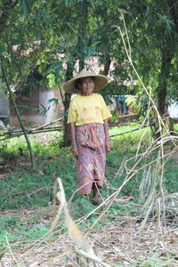 Portrait of a girl standing by tree