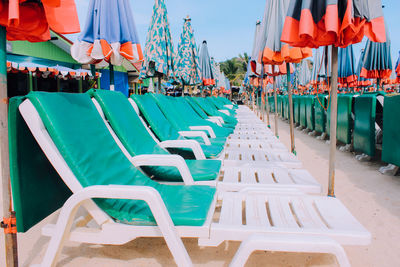 Chairs at beach against sky