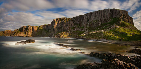 Scenic view of sea and mountains against sky