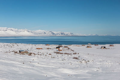 Scenic view of beach against clear blue sky