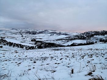 Scenic view of snow covered mountains against sky