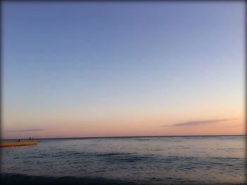 Scenic view of sea against clear sky during sunset