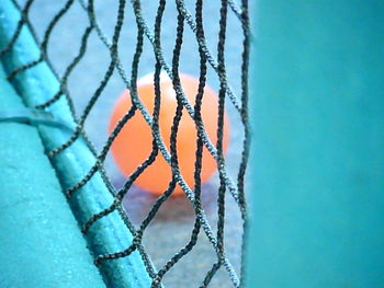 High angle view of ball seen through net