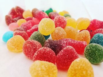 Close-up of colorful candies on white table
