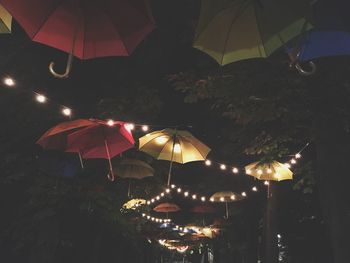 Low angle view of illuminated lanterns hanging at beach