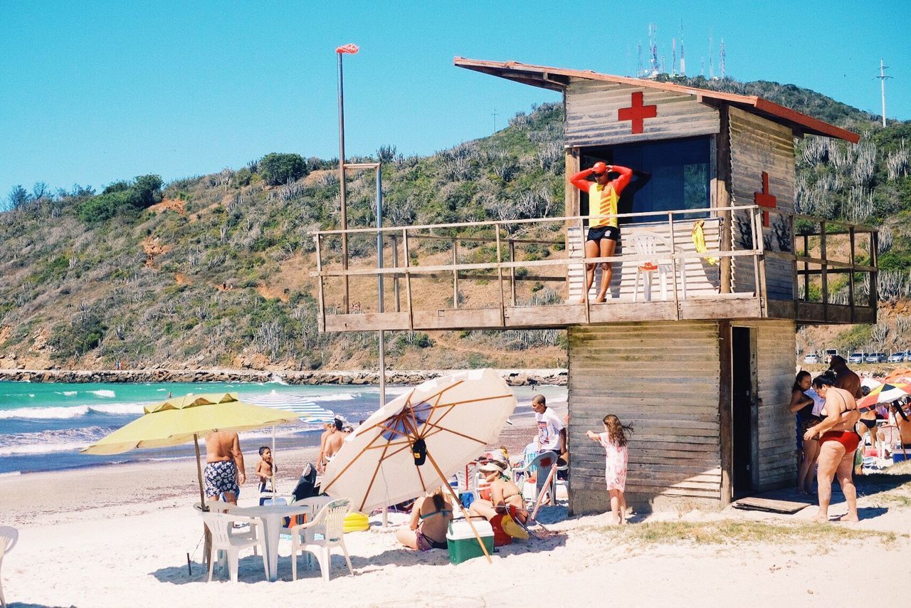 PEOPLE ON BEACH AGAINST SKY