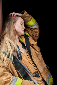 Side view of female firefighter with hand in hair