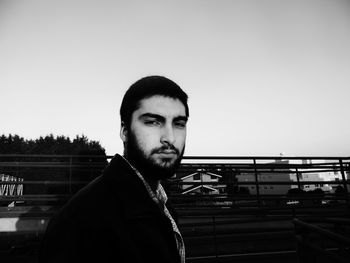 Portrait of man standing against clear sky