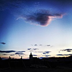 Built structure against cloudy sky at sunset