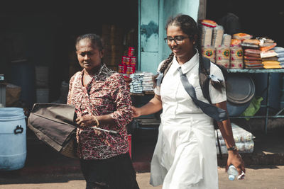 Portrait of a smiling young couple standing outdoors