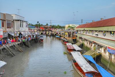 Boats in canal along buildings