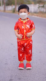 Portrait of boy standing on road