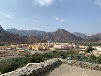 Scenic view of buildings and mountains against sky