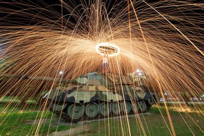 Blurred motion of man with fire crackers at night