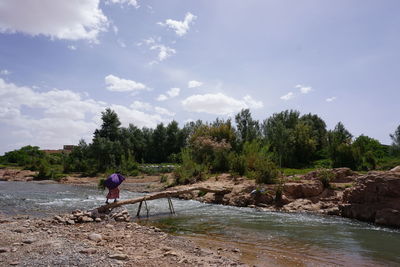 Rear view of man working against sky