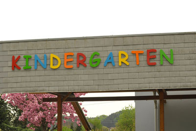 Low angle view of sign against clear sky