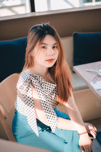 Portrait of young woman sitting in car