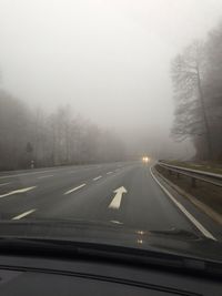 Road passing through foggy weather