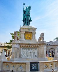 Low angle view of statue against cloudy sky