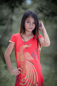 Portrait of young woman standing outdoors