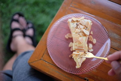 Low section of woman holding ice cream