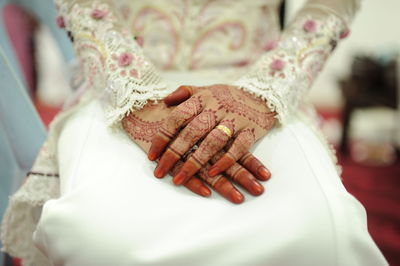Close-up of bride sitting on chair during wedding