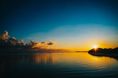 Scenic view of island sea against sky during sunset