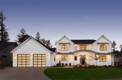 Beautiful modern farmhouse style luxury home exterior at twilight