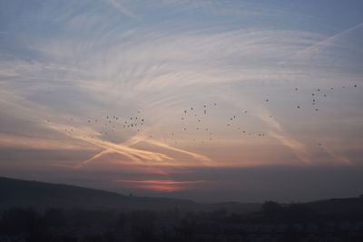 Scenic view of landscape against sky at sunset